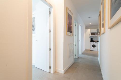 a hallway with a door leading to a kitchen at Edificio Santiago by Plaza Mayor Apartamentos in Valladolid