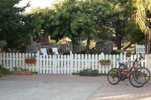 two bikes parked next to a white fence at The Garden of Zephyrus - East in Pithárion