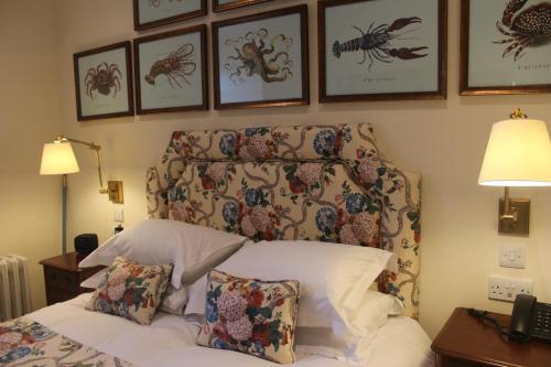 a bedroom with a bed with a headboard with crabs on the wall at The Granary Lodge Bed & Breakfast in Thurso