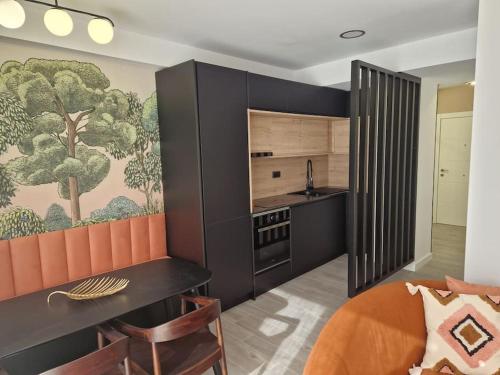 a kitchen with a dining table and a kitchen with a painting at Dúplex de diseño Jaén Centro Jardinillos - 2 Hab in Jaén