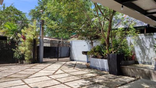 a patio with a fence and a tree at Ezekiel Transient House in Coron
