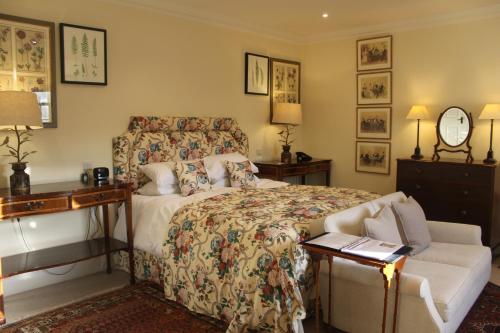 a bedroom with a bed and a desk and a couch at The Granary Lodge Bed & Breakfast in Thurso