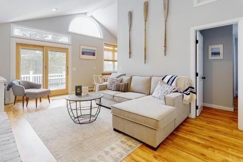 a living room with a couch and a table at Deer Run Retreat in Gilford
