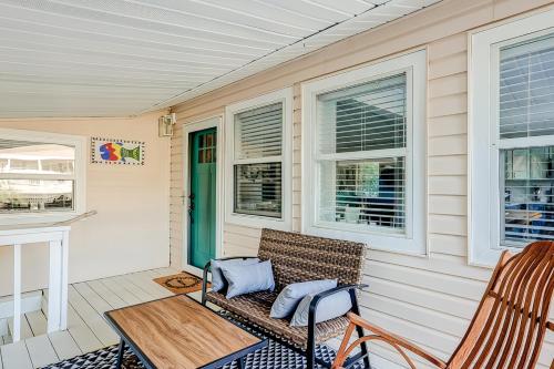 a porch with a bench and a table and two chairs at Barefoot Lizzy's in Edisto Island