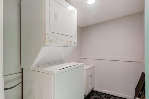 a white kitchen with a refrigerator and a stove at Barefoot Lizzy's in Edisto Island