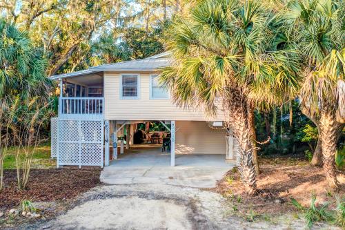 a house with a palm tree in front of it at Barefoot Lizzy's in Edisto Island