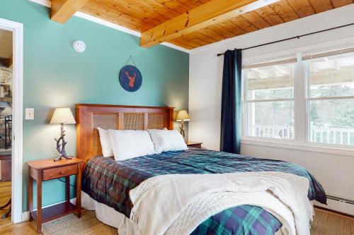 a bedroom with a bed and a window at Deer Run Retreat in Gilford