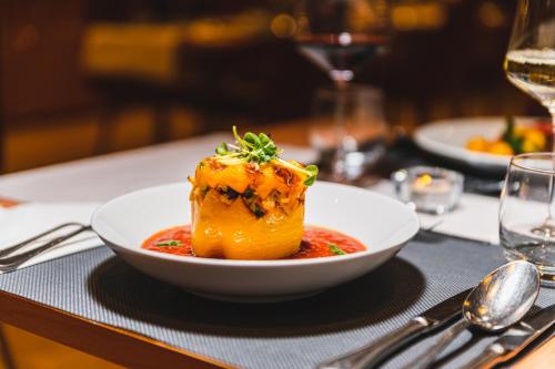 a white bowl of food on a table at Hotel Tia Monte Nauders in Nauders