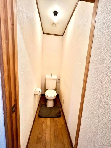 a bathroom with a toilet in a small room at Shirahama in Miyazaki