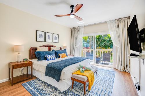 a bedroom with a large bed and a window at Poipu Mermaid 912 in Koloa