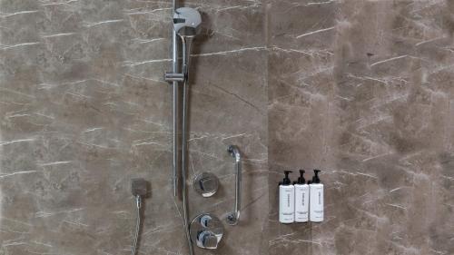a shower with two bottles of wine on a wall at Crowne Plaza Florya Istanbul by IHG in Istanbul