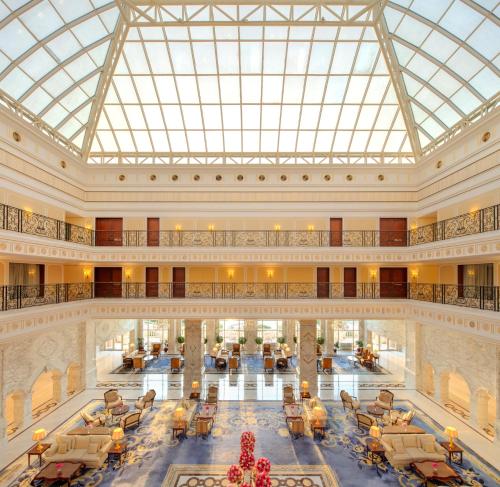 a large lobby with a large glass ceiling at The Regency Hotel Kuwait in Kuwait
