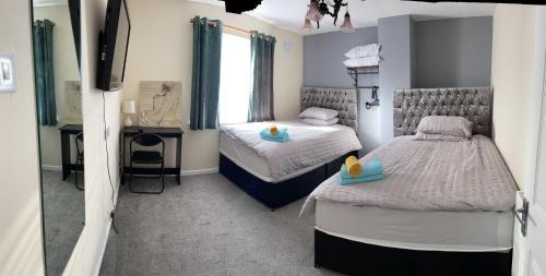 a bedroom with two beds and a mirror at 116 Maison Dieu Road Room C in Dover in Dover