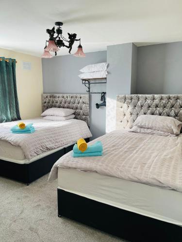 a bedroom with two beds with towels on them at 116 Maison Dieu Road Room C in Dover in Dover