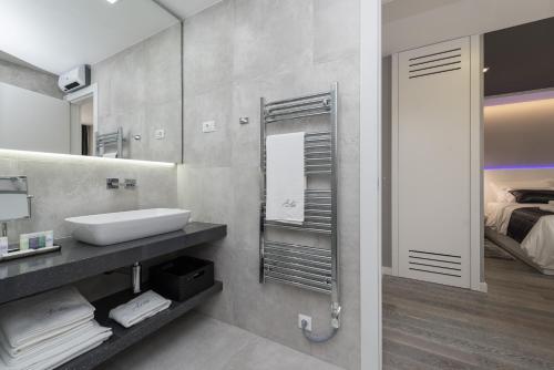 a bathroom with a sink and a mirror at Artis Accommodation Lux in Zadar