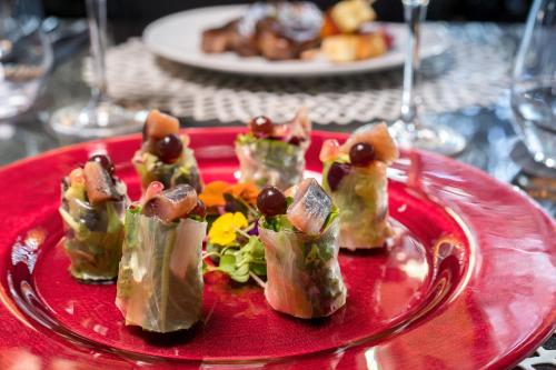 a plate of food on a red plate at Barceló Raval in Barcelona