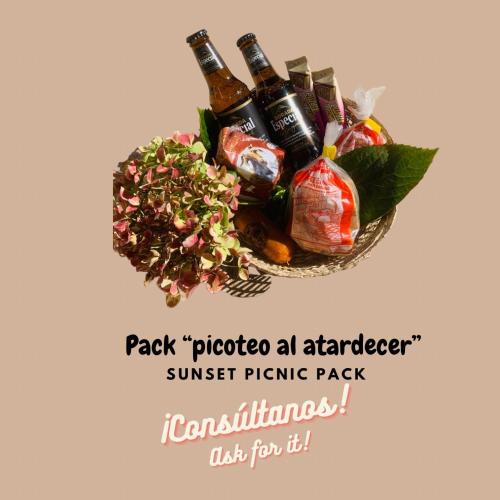 a basket filled with bottles of beer and a salad at Apartamento La Cueva, Artenara By Artenatur in Artenara