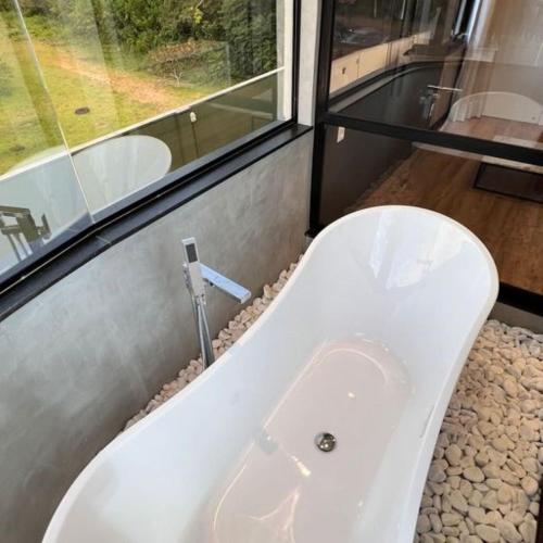 a white bath tub sitting next to a window at Cataratas Park Hotel e Eventos in Foz do Iguaçu