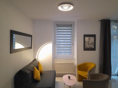 a living room with a couch and a chair at 17, face à la gare in Lannion