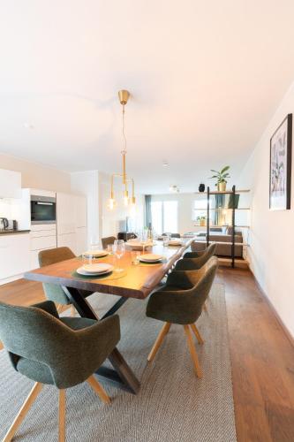 uma sala de jantar com uma mesa de madeira e cadeiras em -Zentrale Wohnung-Balkon-Desingerküche- em Bielefeld