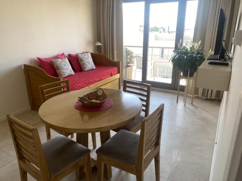 a living room with a table and chairs and a couch at Departamento Completo Tandil in Tandil