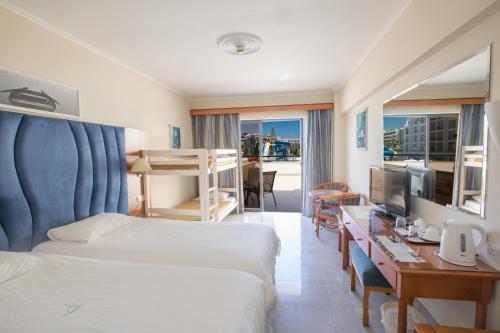 a hotel room with two beds and a television at Anastasia Waterpark Beach Resort in Protaras