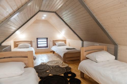 a room with three beds in a attic at Апартаменти Гармонія in Mizhhirya