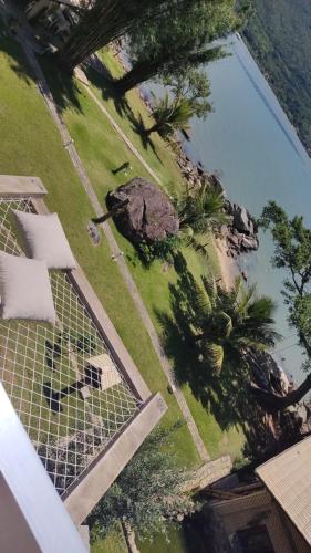 an aerial view of a swimming pool with trees at Paraíso da Enseada de Brito in Palhoça