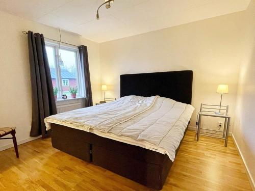 1 dormitorio con 1 cama grande y ventana grande en Holiday home SÖLVESBORG XVI, en Sölvesborg