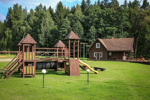 a park with a playground with a slide at Guest House Mednieki in Salainis