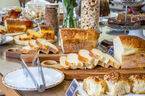 a table filled with bread and other foods on a table at Green Village Hotel in Monte Verde