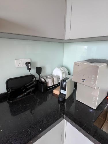 a kitchen counter with a coffee maker and a toaster at METROPOL SERVICED APARTMENT at Bukit Mertajam, Pulau Pinang in Bukit Mertajam