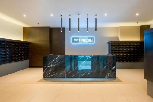 a lobby with a counter with a marble slab at METROPOL SERVICED APARTMENT at Bukit Mertajam, Pulau Pinang in Bukit Mertajam