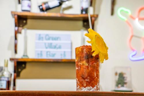 a drink on a counter with a spoon in it at Green Village Hotel in Monte Verde