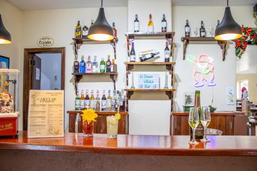 a bar with bottles and glasses on a counter at Green Village Hotel in Monte Verde