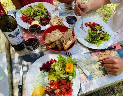 a table with plates of food and glasses of wine at Domaine de Séguéla in Fargues