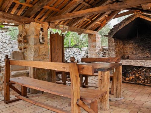 a wooden bench sitting in front of a building at Sage House in Trpanj
