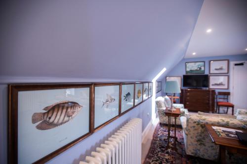 a living room with many pictures on the wall at The Granary Lodge Bed & Breakfast in Thurso