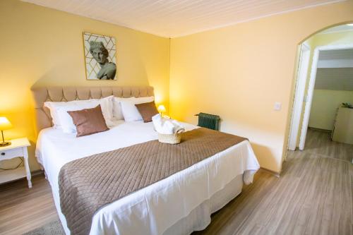 a bedroom with a large bed in a room at Green Village Hotel in Monte Verde