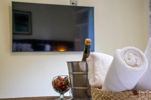 a bottle of champagne in a basket on a table at Green Village Hotel in Monte Verde