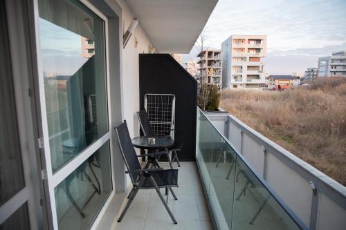 a balcony with a table and chairs on it at Sunny Blue Studio in Mamaia Sat/Năvodari