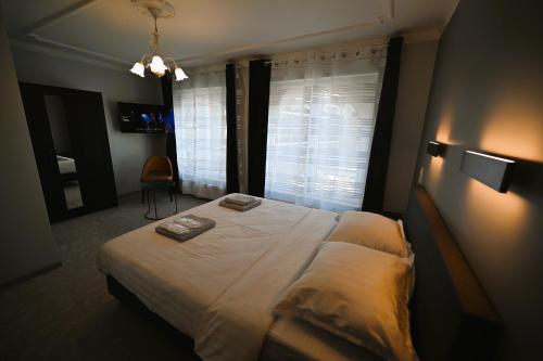 a bedroom with a large bed with a window at Cesar Palace in Ostend