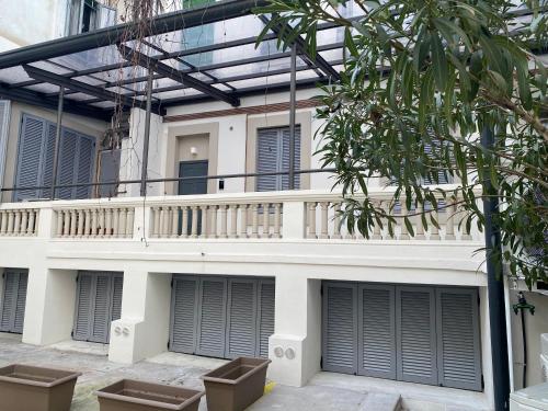 a white building with a balcony on it at #milanodabere Urban Loft in Milan