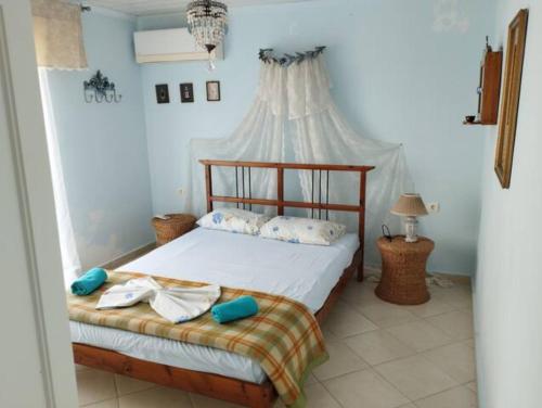 a bedroom with a bed with a canopy at VILLEA VILLAGE in Kalamitsi