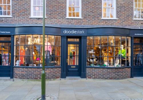 a store front of a brick building with a store at Talbot Lane Cottage Horsham By My Getaways in Horsham