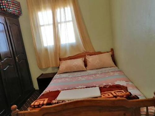 a bed in a bedroom with a window at Takad Dream Rural in Takate