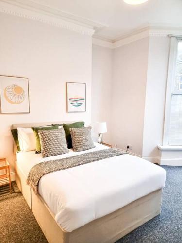 a white bedroom with a large bed in it at Gorgeous Newly Renovated 2 Double Bed Flat in Swansea