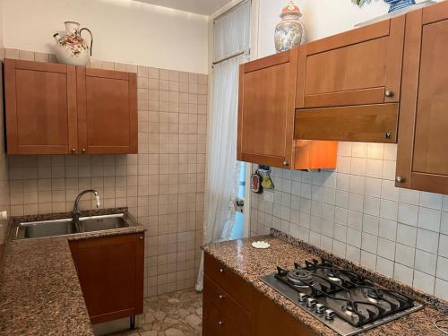 a kitchen with a sink and a stove top oven at Appartamento Ellidor in Lido di Jesolo