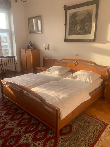 a bedroom with a large bed with a wooden frame at Anastasia in Mediaş