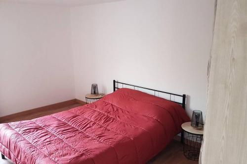 - une chambre avec un lit rouge et 2 tables dans l'établissement Joli appartement 2 chambres à Martigues, à Martigues
